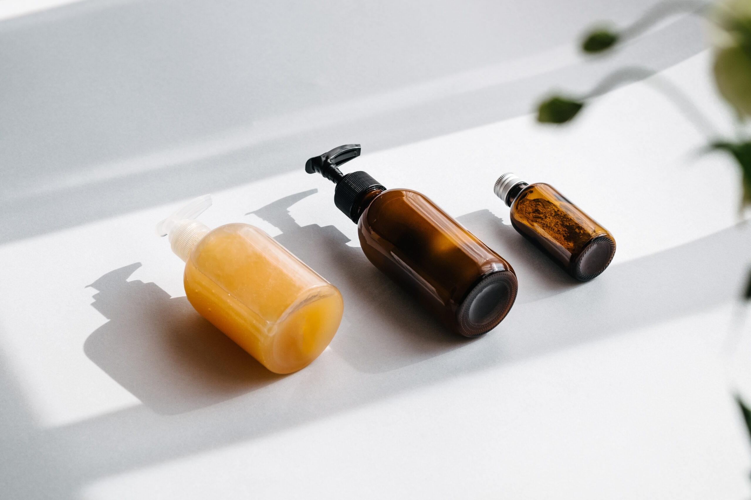 Glass brown bottles with organic cosmetics overhead. Direct light. Beauty blogging minimalism concept