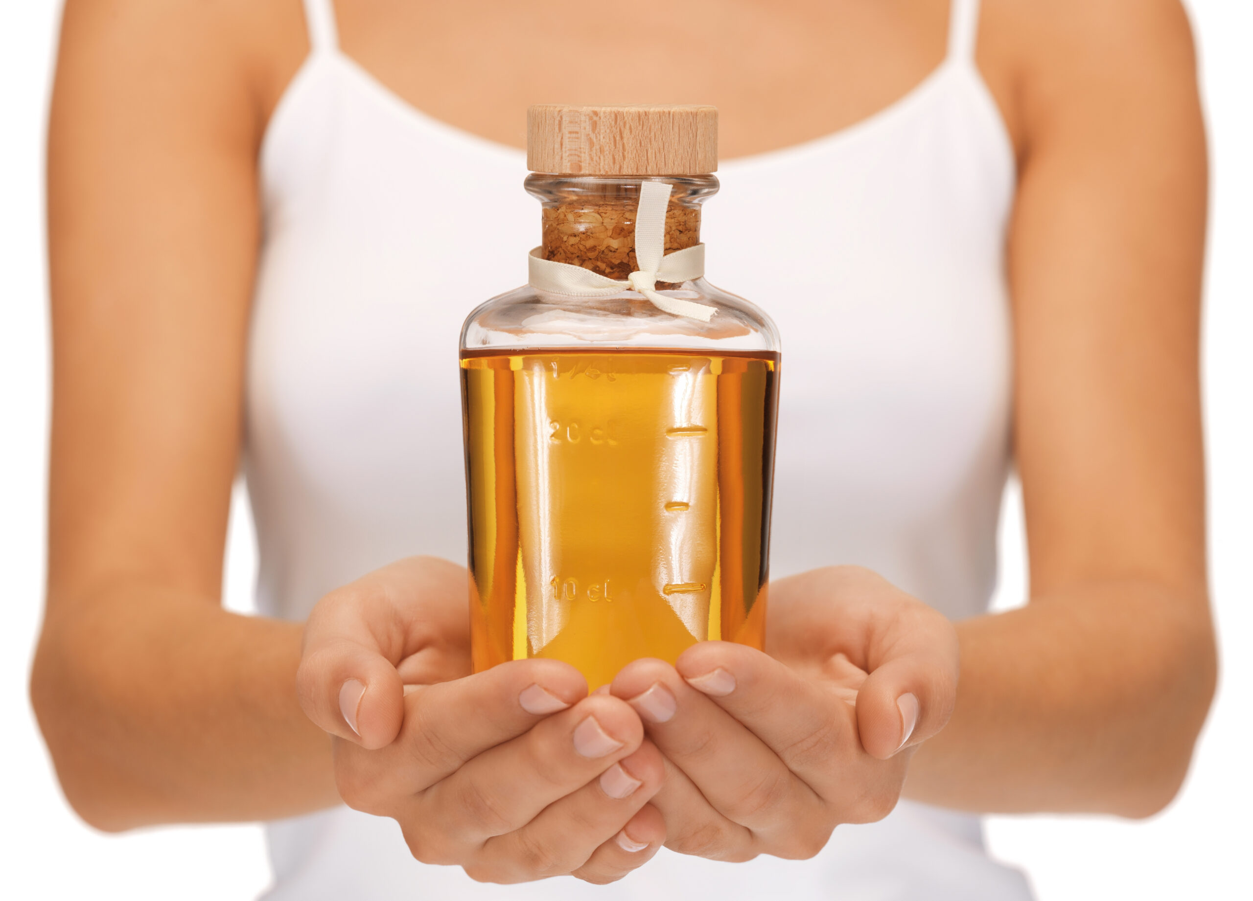 female hands with oil bottle
